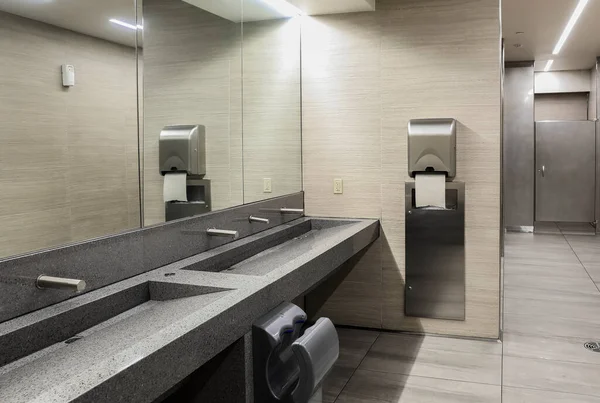 Seramik lavabolu banyo, ayna ve ayrı bölmeler.