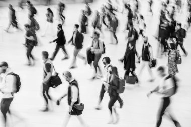Blur of focus, people walk up the stairs in the lobby of a public building