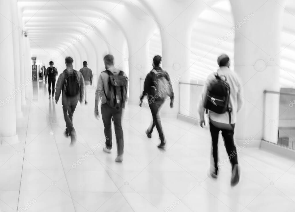 Abstract image of people in the lobby of a modern business center with a blurred background