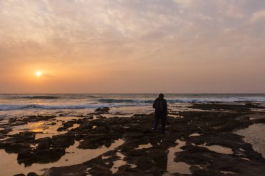 Man on the beach during sunset