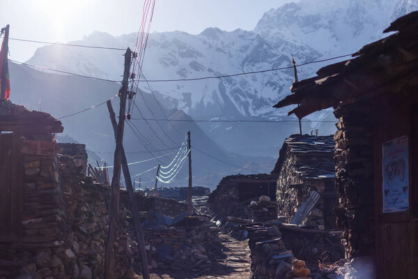Houses against the backdrop of snow-capped mountains in the Himalayas