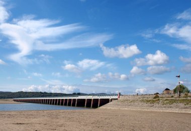 view of the beach at arnside with the leven railway viaduct and river in the south lakes area of cumbria clipart