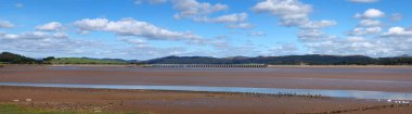 panoramic view of the beach at canal foot in ulverston with a view of the beach a river leven with morecambe bay in the distance clipart