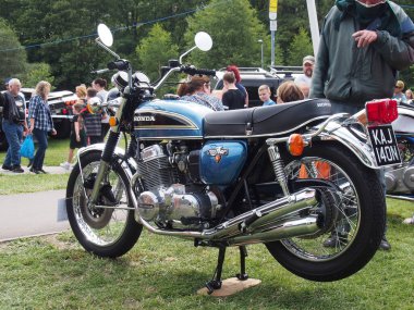 hebden bridge, west, yorkshire, united kingdom - 7 August 2022: blue vintage honda 750 four motorcycle at hebden bridge vintage weekend surrounded by people