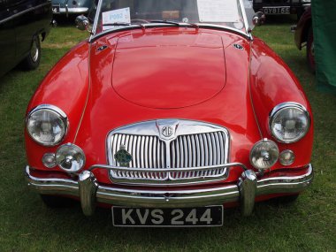 hebden bridge, west, yorkshire, united kingdom - 7 August 2022: front view of the headlights and bumper of a red mga sports car at the Annual Hebden Bridge Vintage Weekend Vehicle Show