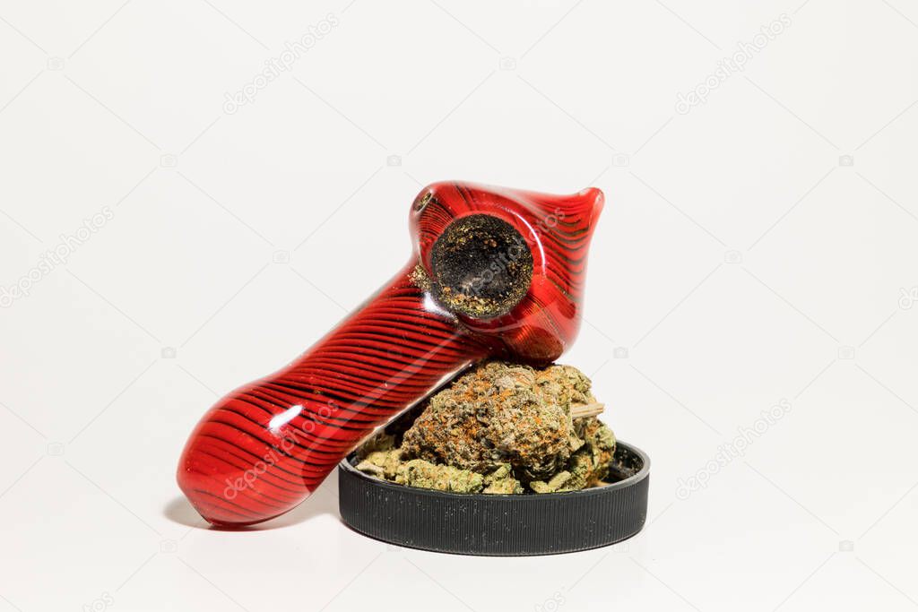 Marijuana pipe and jar of weed