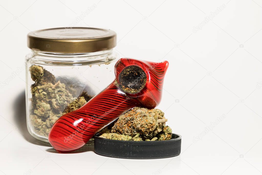 Marijuana pipe and jar of weed