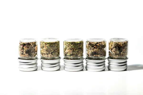 Closeup Marijuana Buds Glass Jars Isolated White Background — стоковое фото