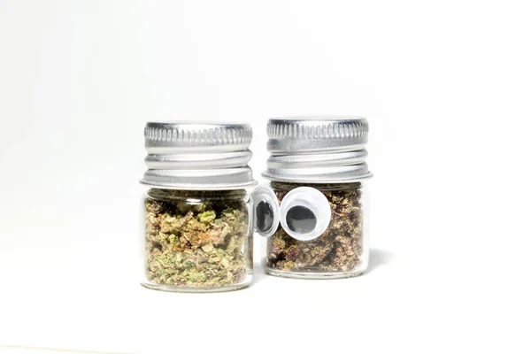 Closeup Marijuana Jars Cannabis Character Eyes White Background — стоковое фото