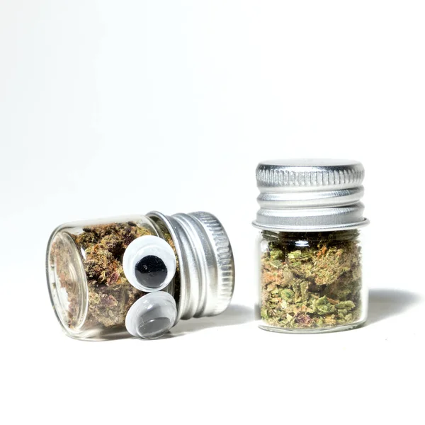 Closeup Marijuana Jars Cannabis Character Eyes White Background — стоковое фото