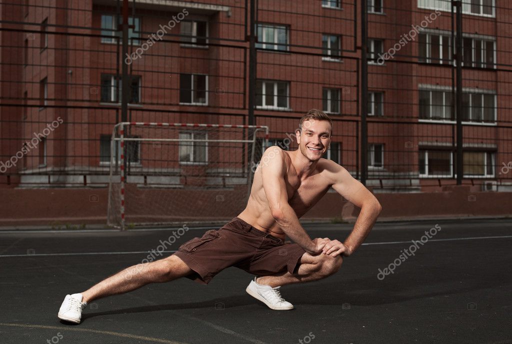 Athletic trainer warming up — Stock Photo © danilkorolev 29648851