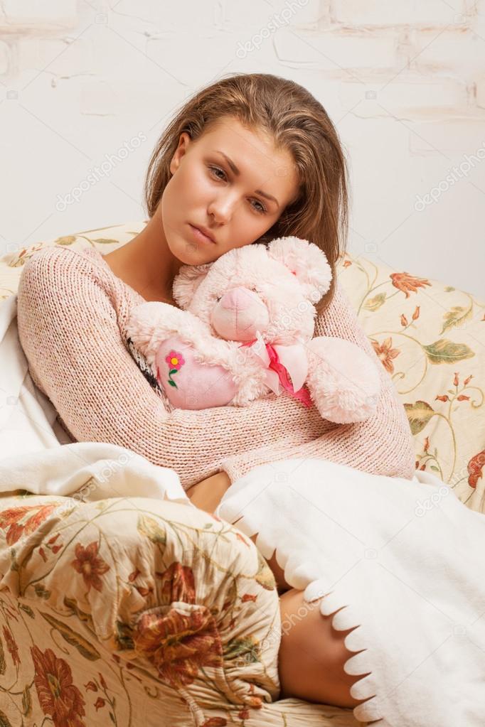 girl hugging a teddy bear
