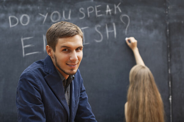 a couple of students at the blackboard with the words