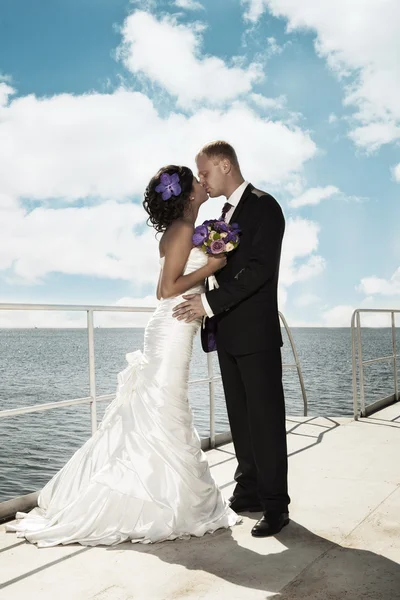 Frischvermählte küssen sich auf dem Pier — Stockfoto