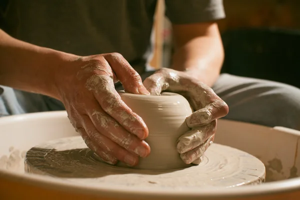 Hands working on pottery wheel , close up retro style toned — Stock Photo, Image