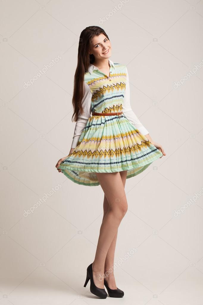 The beautiful girl poses in studio. Catalog. Posing of professio