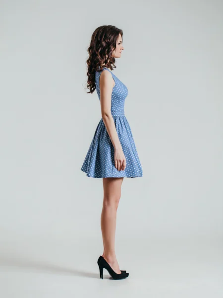 Young brunette lady in color dress. — Stock Photo, Image