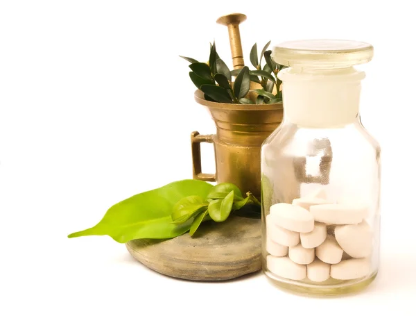 Mortar and pharmacy bottle, with herbs — Stock Photo, Image