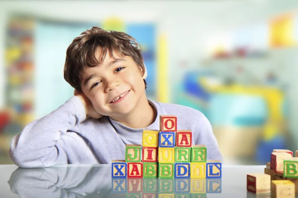 Happy child with wooden cubes — Stock Photo, Image