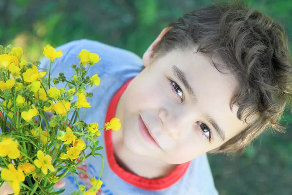 Chlapec s kyticí lučních květin — Stock fotografie