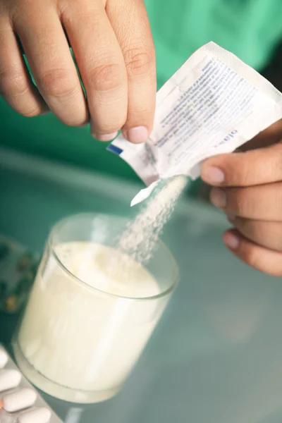 Man is throwing the medicine in the glass — Stock Photo, Image