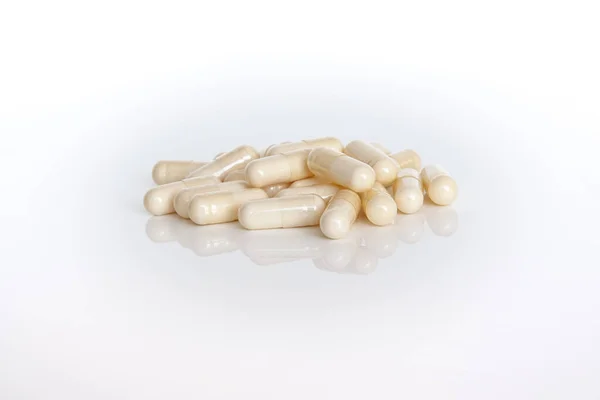 A pile of vitamin capsules isolated on white background