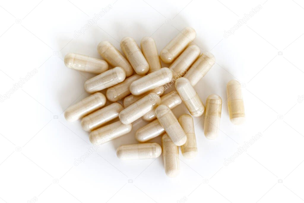 A pile of vitamin capsules from above isolated on white background