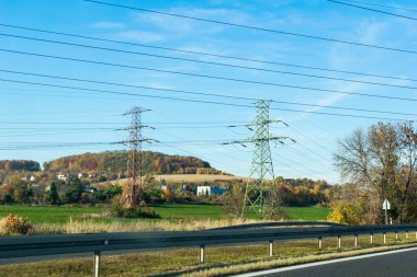 power poles on the background of fields and forests