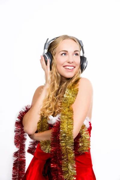 Christmas girl totaly in the mood and listening to christmas songs — Stock Photo, Image