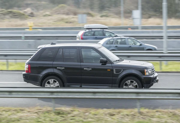 Range Rover driving down the road