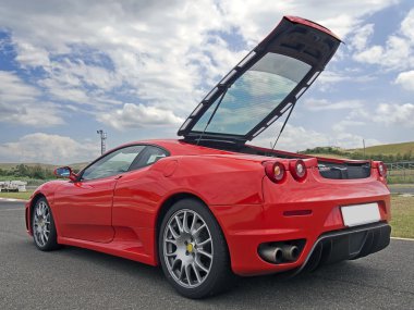 red ferrari f430 with tailgate open