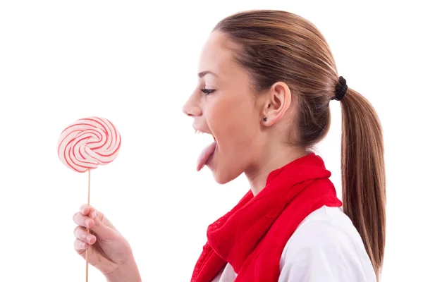 Beautiful girl holding and licks a lollipop — Stock Photo, Image