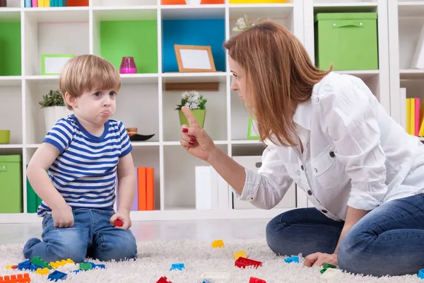 Angry mother scolding a disobedient child Stock Photo