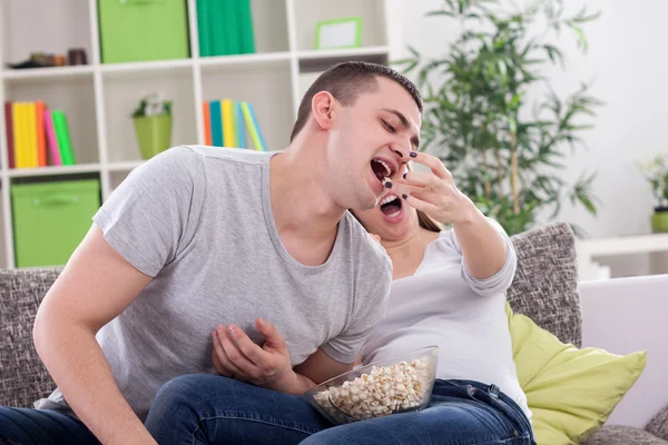 Girl feeding her boyfreind — Stock Photo, Image