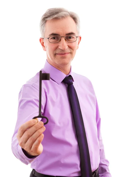 Businessman in purple holding key — Stock Photo, Image