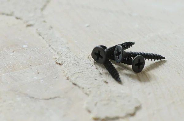 Set of screws on the grunge wood background — Stock Photo, Image