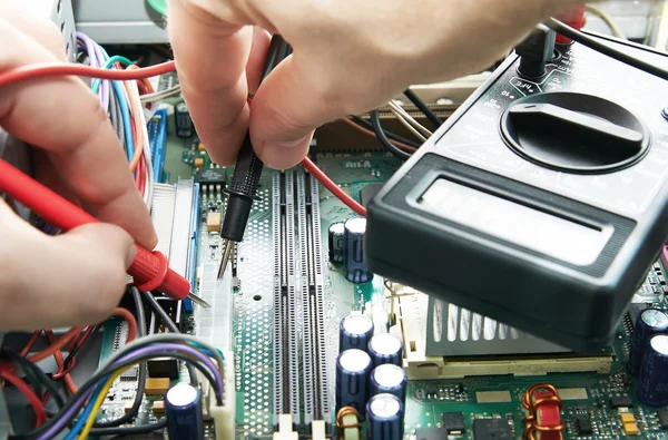 Close-up of a technician hands with voltmeter — Stock Photo, Image