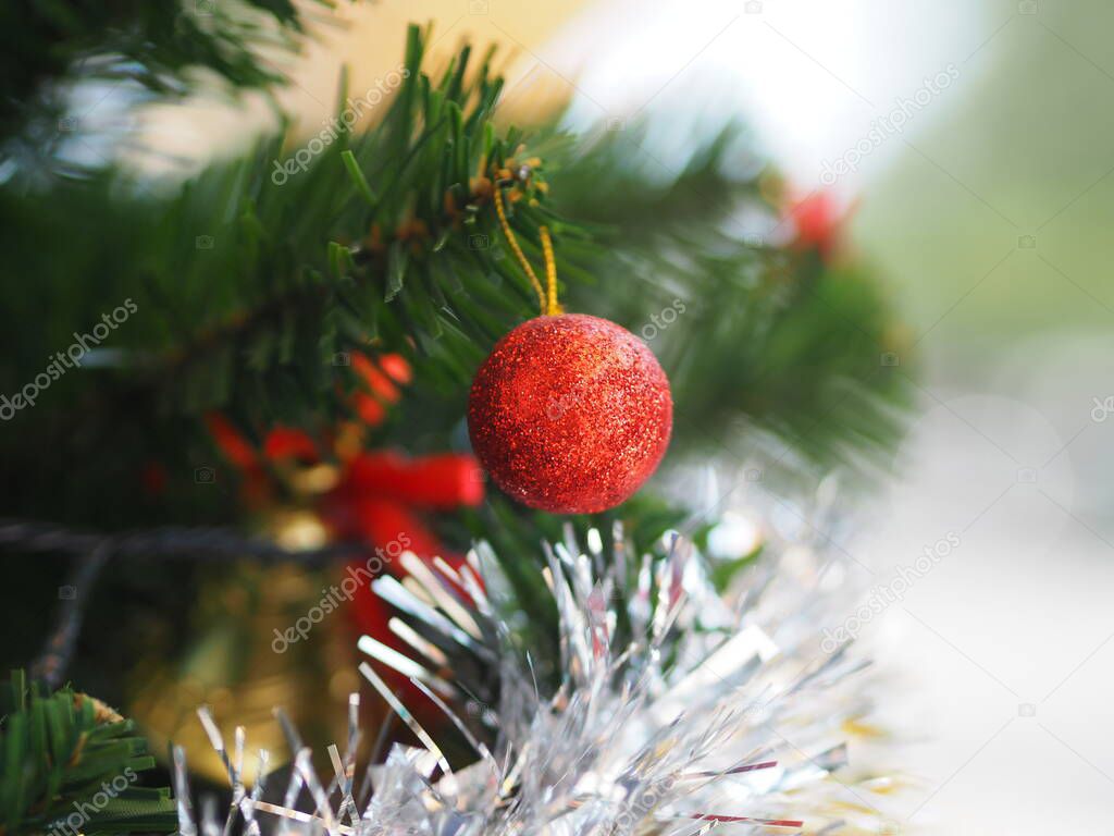 Decorated Christmas green tree decorations have Gift box gold red ball hanging pine, leaves on blurred of background