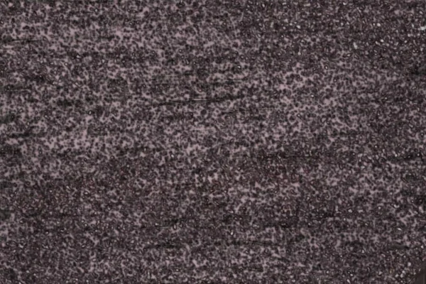 花崗岩の石の性質花崗岩の原石の表面仕上げ壁 床材黒とグレーの色 ドット白赤の背景 常にタイトテクスチャ 耐久性を持っています — ストック写真