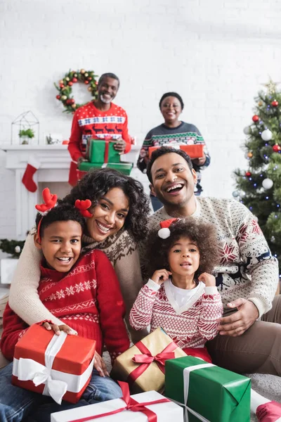 Happy African American Family Smiling Camera Blurred Grandparents Christmas Presents — Stock Photo, Image