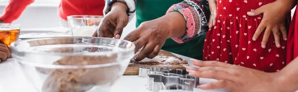 cropped view of african american family cooking for christmas in kitchen, banner