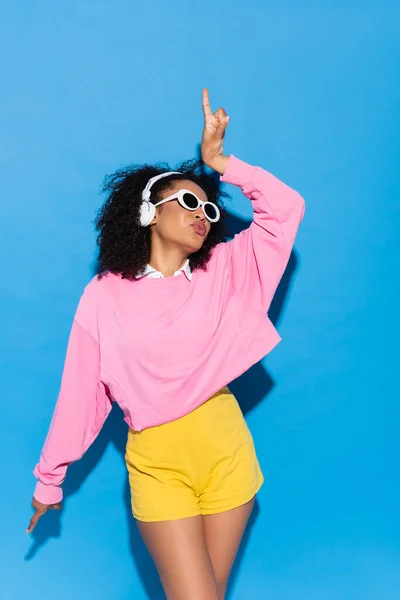 Excited African American Woman Wireless Headphone Pouting Lips While Dancing — Stock Photo, Image