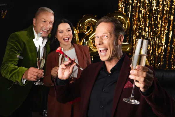 Excited Mature Man Party Horn Champagne Standing Interracial Friends New — Stock Photo, Image