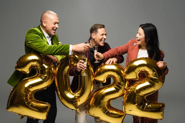 Cheerful Multiethnic Friends Toasting Champagne Balloons Shape 2022 Numbers Isolated — Stock Photo, Image