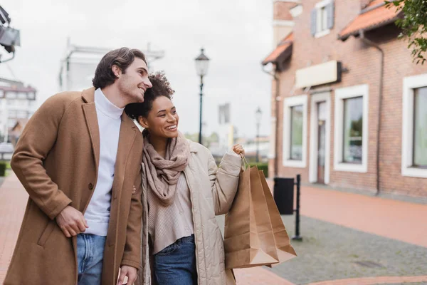 Cheerful African American Woman Holding Shopping Bags Boyfriend Outdoors — Stock Photo, Image