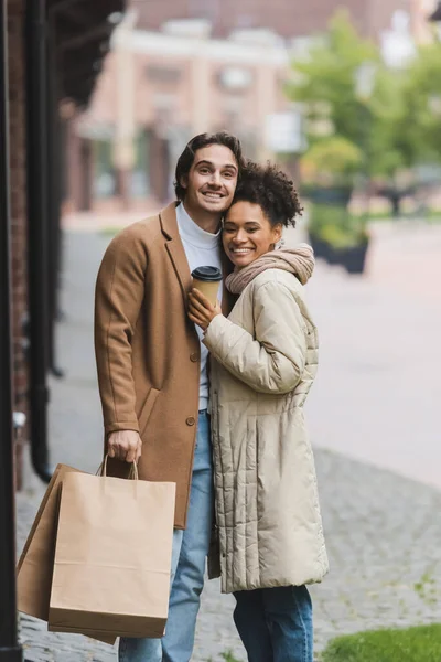 Happy African American Woman Holding Paper Cup Smiling Boyfriend Shopping — Stock Photo, Image