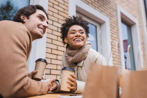 Happy Interracial Couple Holding Hands Coffee Blurred Shopping Bags — Stock Photo, Image