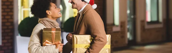 Happy Man Santa Hat African American Girlfriend Looking Each Other — Stock Photo, Image