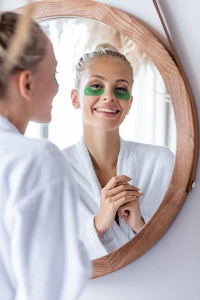 Happy Young Woman Bathrobe Green Eye Patches Smiling Mirror — Stock Photo, Image