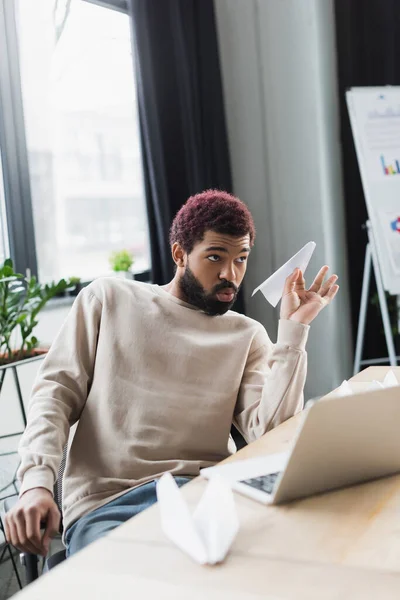 Young African American Businessman Holding Paper Plane Laptop Office — Stock Photo, Image